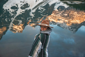 Girl wearing a wide brim hat in the mountains